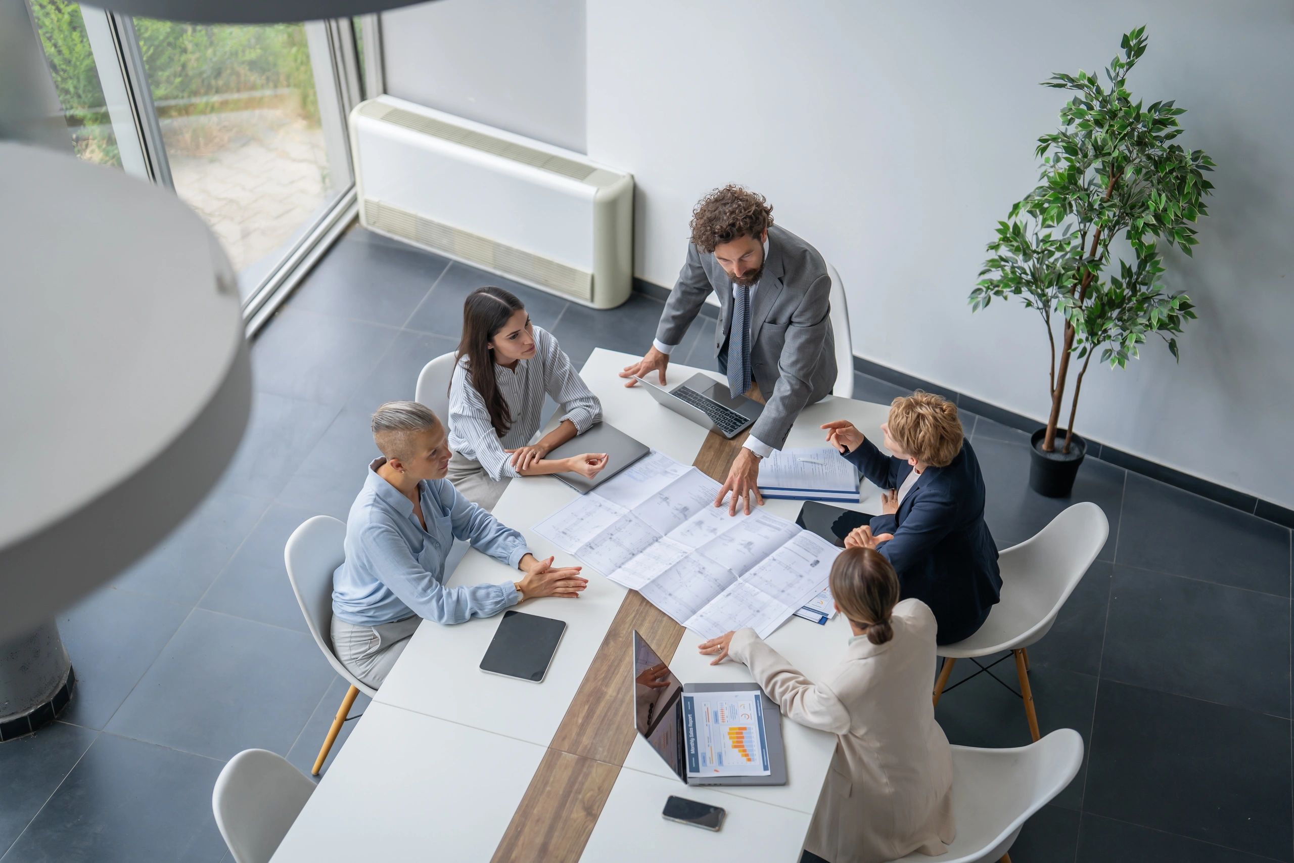 Team reviewing project blueprints in a modern office